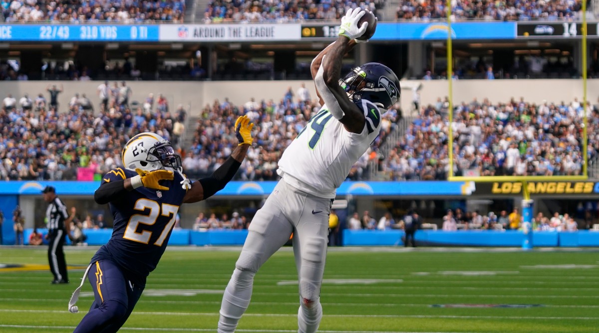 Seahawks wide receiver DK Metcalf (14) reaches for an incomplete pass over Chargers defensive back J.C. Jackson.
